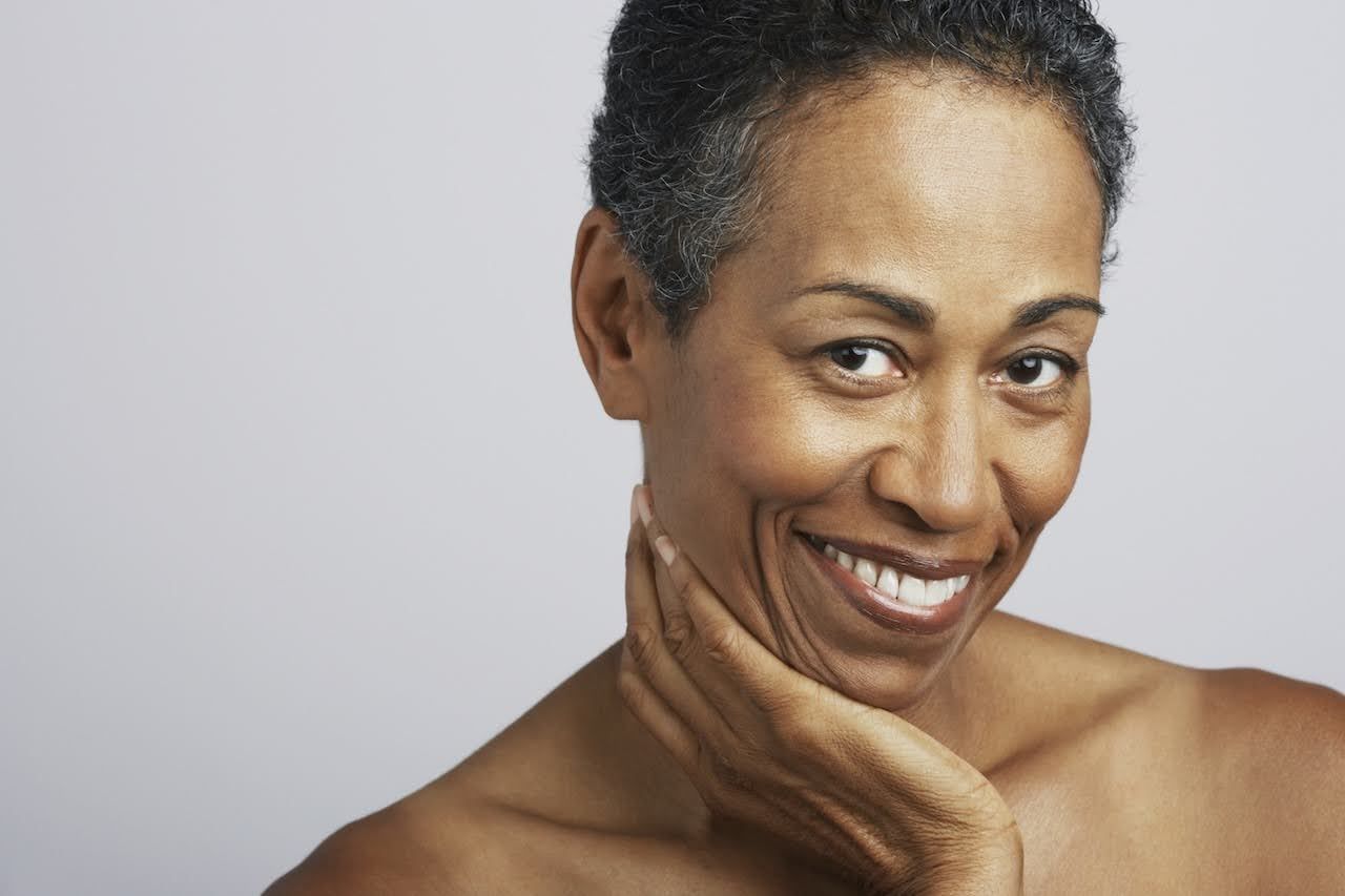 Mature woman feeling confident after using face masque
