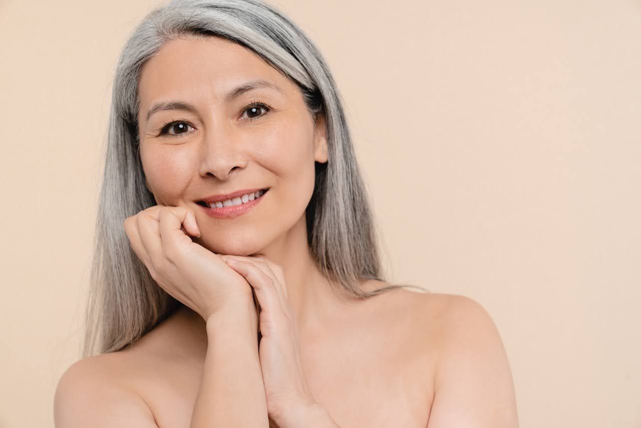 Mature woman showing results of cbd skincare products for sensitive skin