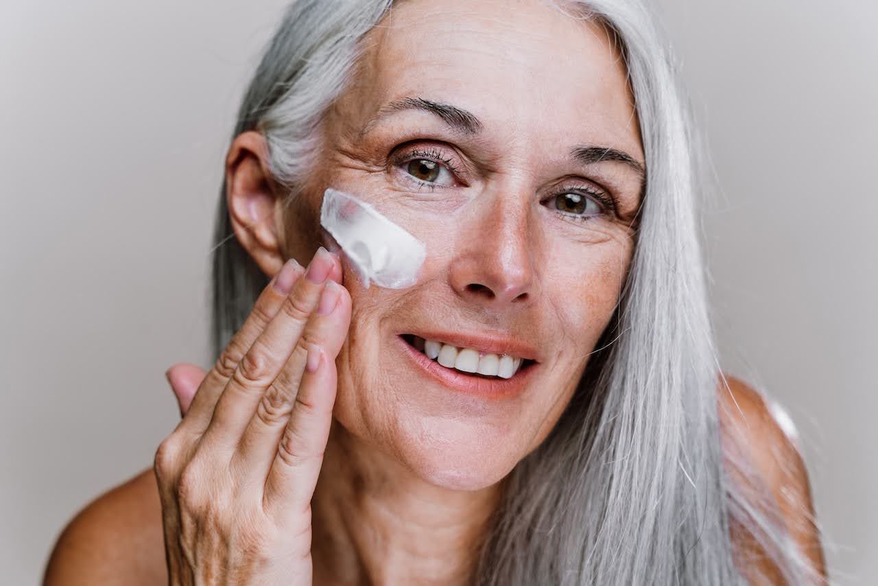 Woman applying a hydrating moisturizer