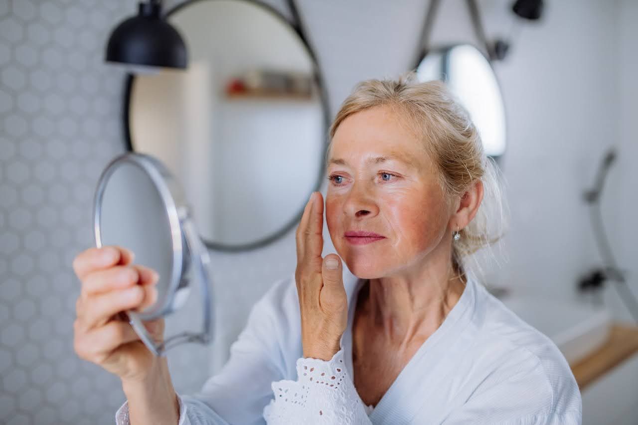 Woman applying cream with hyaluronic acid