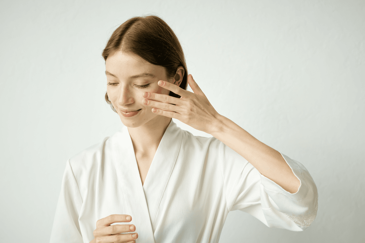 Woman applying face serum