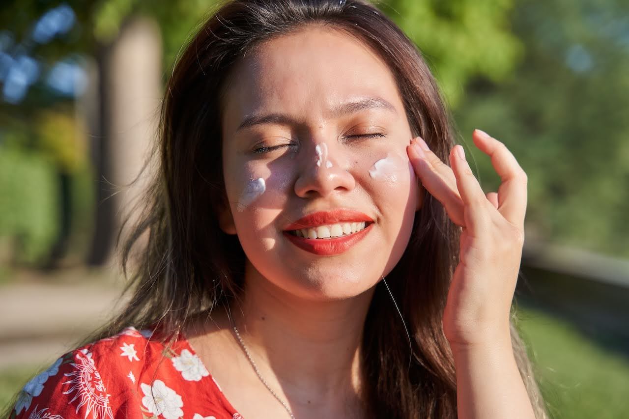 Woman applying sunscreen to protect skin