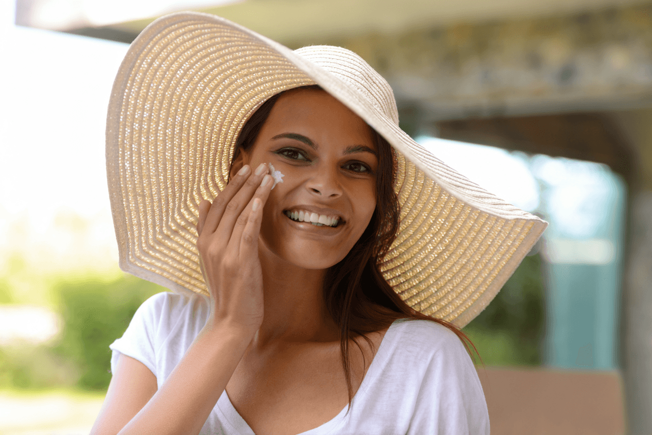 Woman applying sunscreen to protect skin