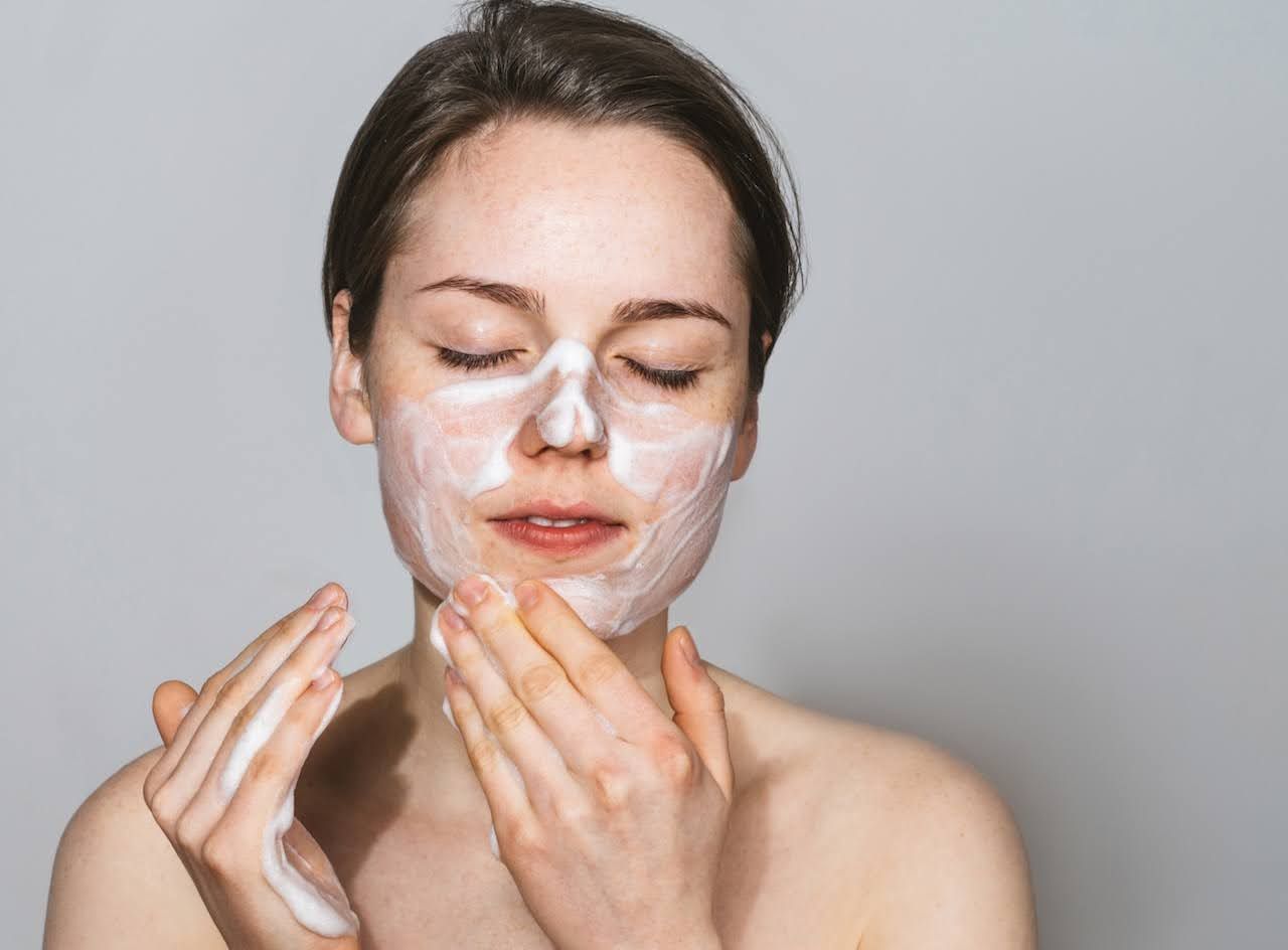 Woman applying ultra gentle cleanser.jpg