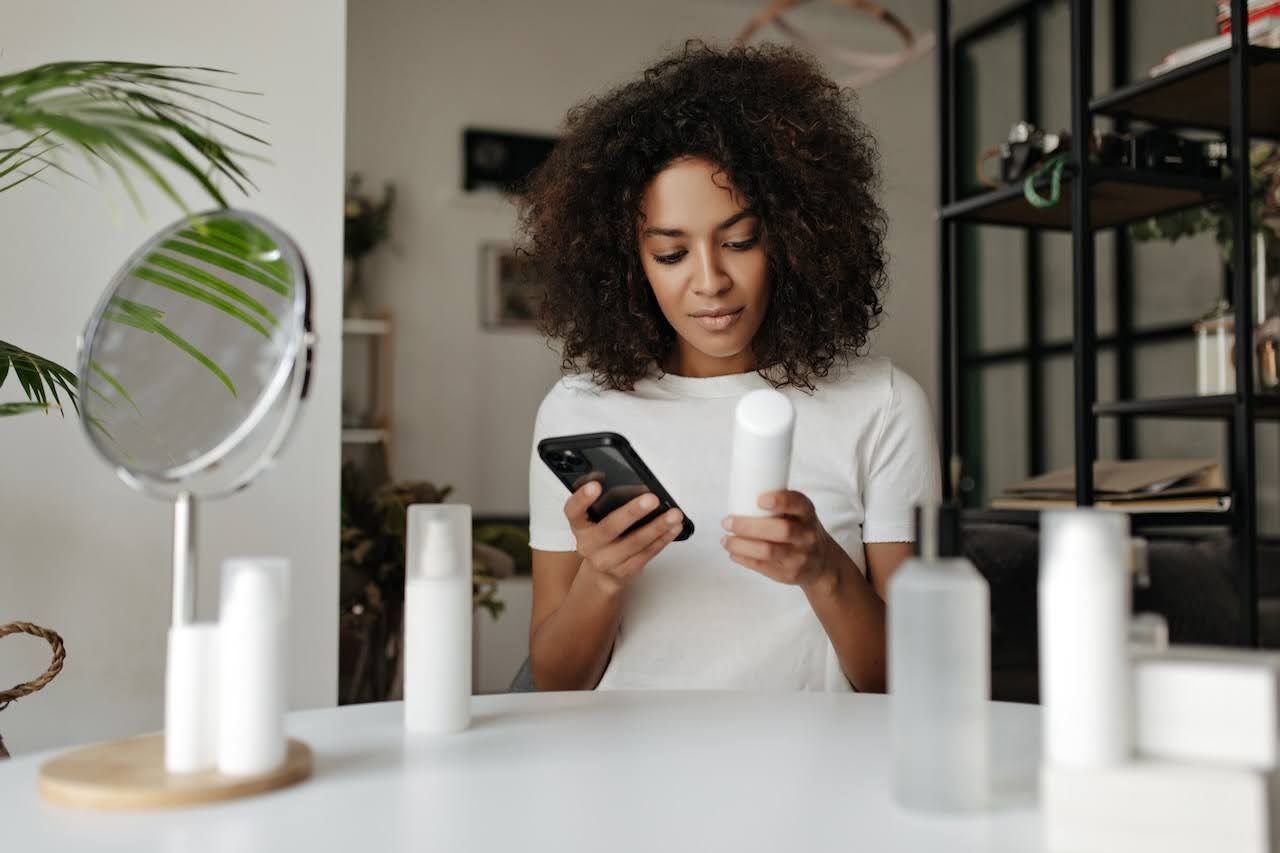 Woman checking skincare ingredients