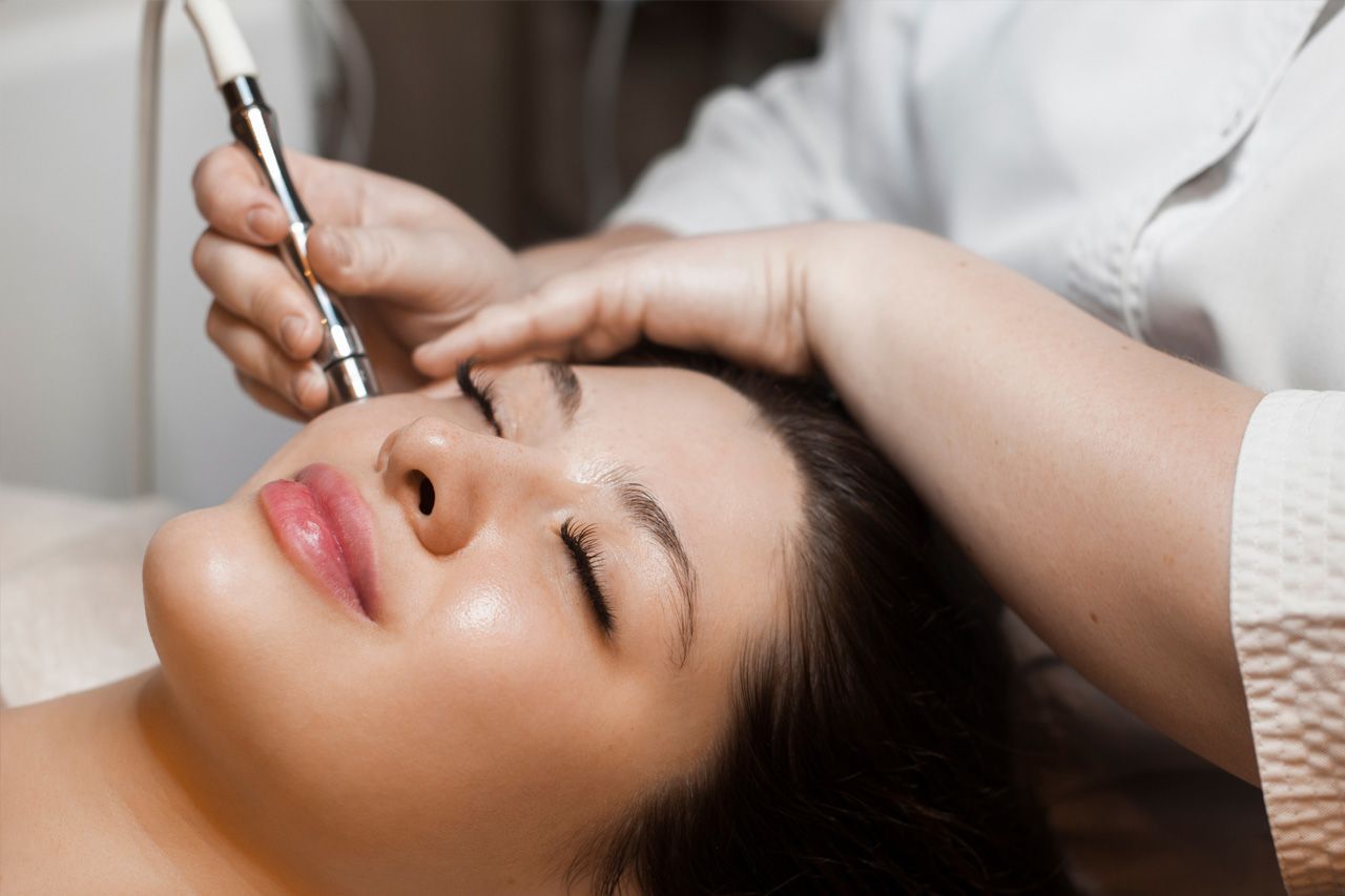 Woman getting microneedling procedure