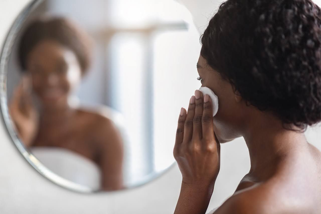 Woman removing calming face masque