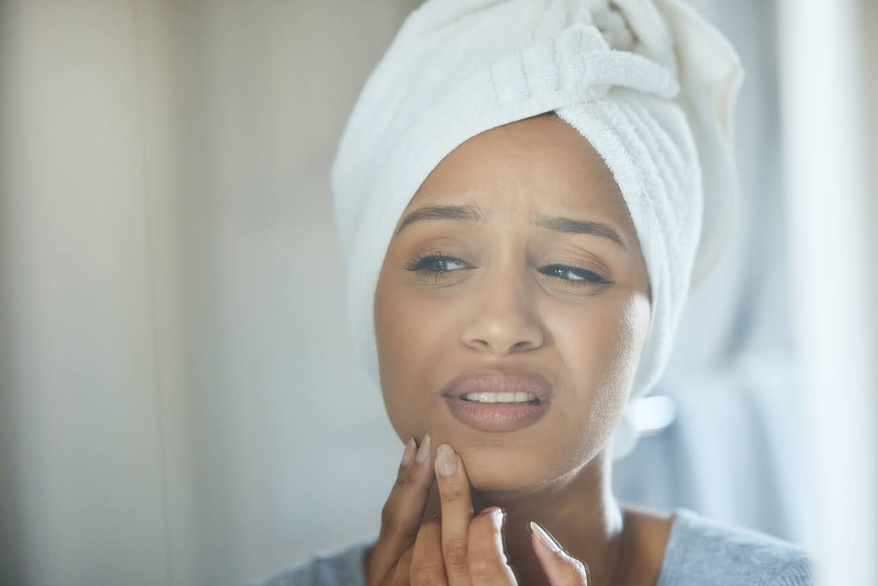 Woman worried about menstrual acne breakout