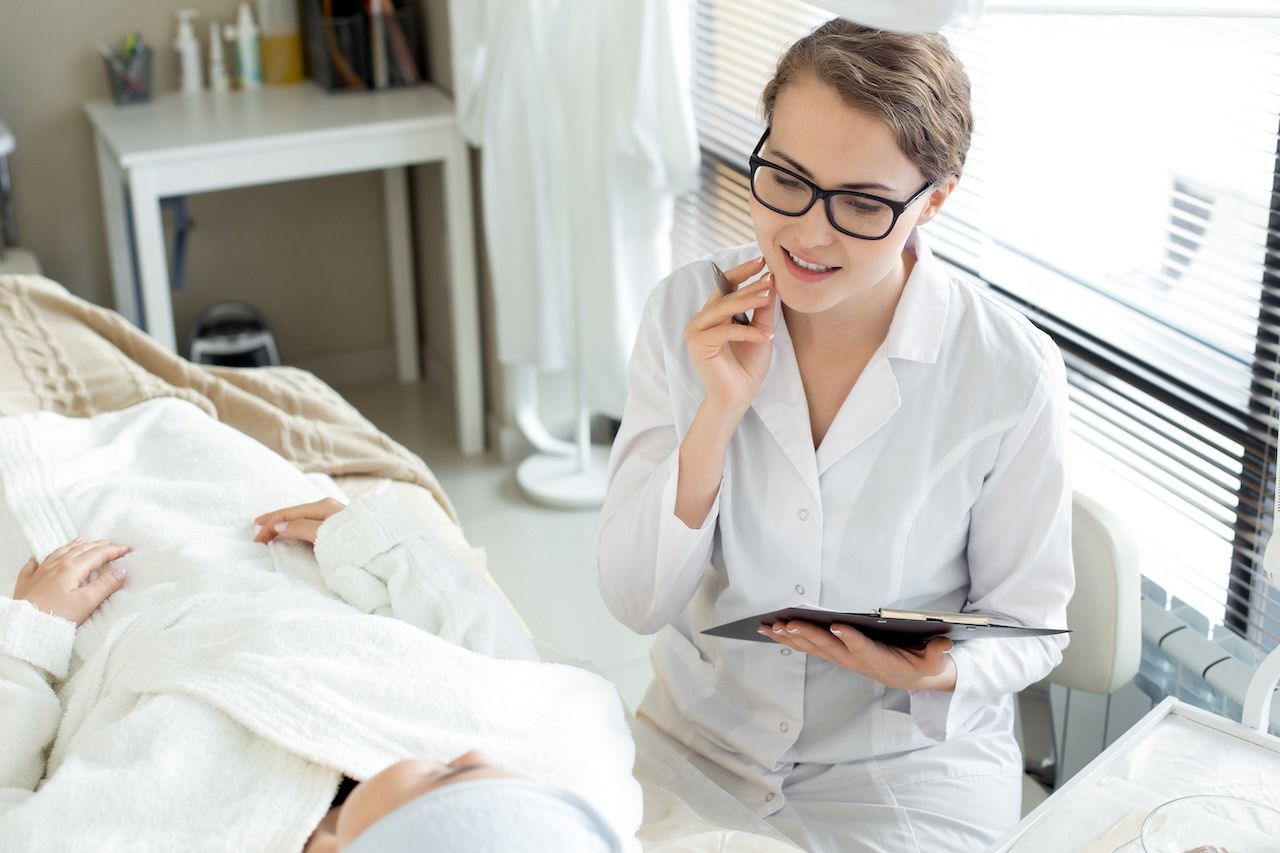 esthetician consulting with a client about persistent breakouts and skincare support