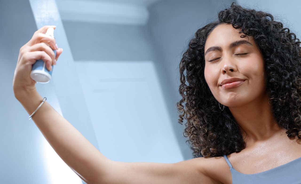woman applying glymed+ cbd skin mist as part of an antioxidant skincare routine