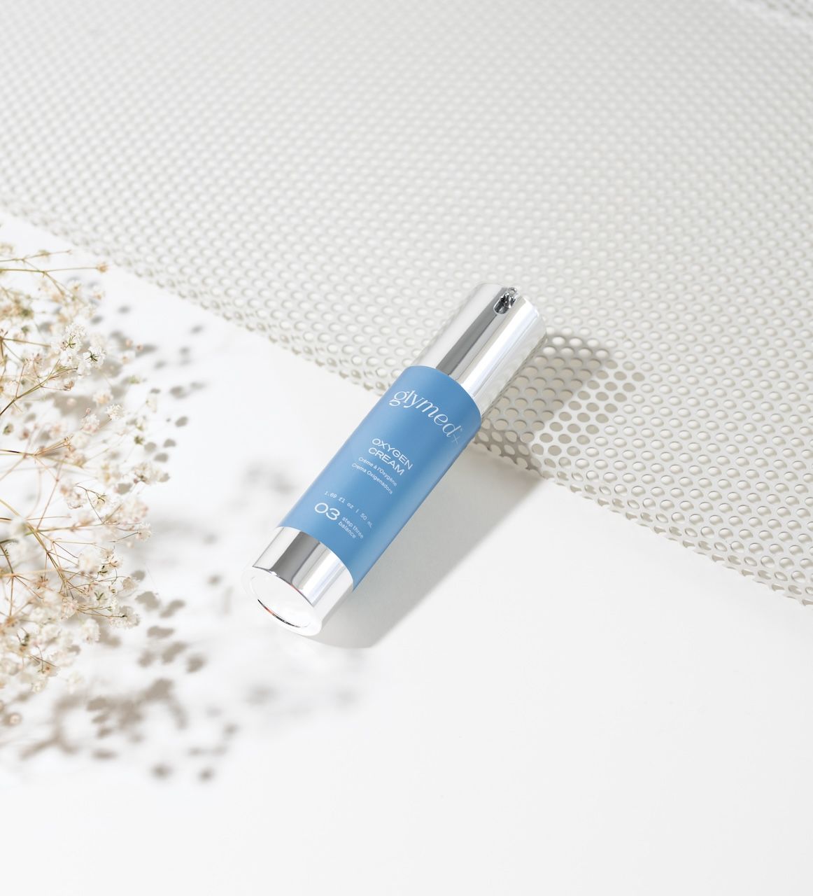 glymed+ oxygen cream displayed on white surface with flowers