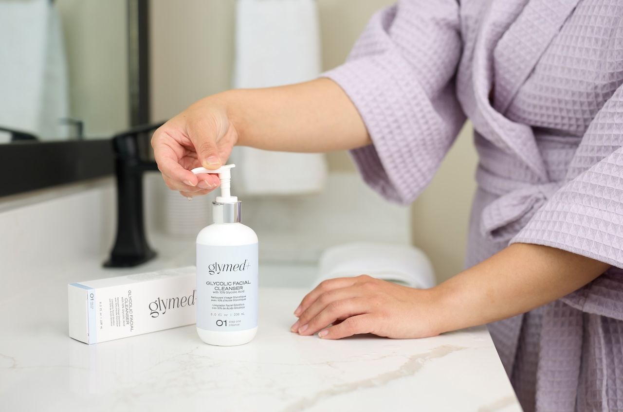 woman dispensing glymed+ glycolic facial cleanser