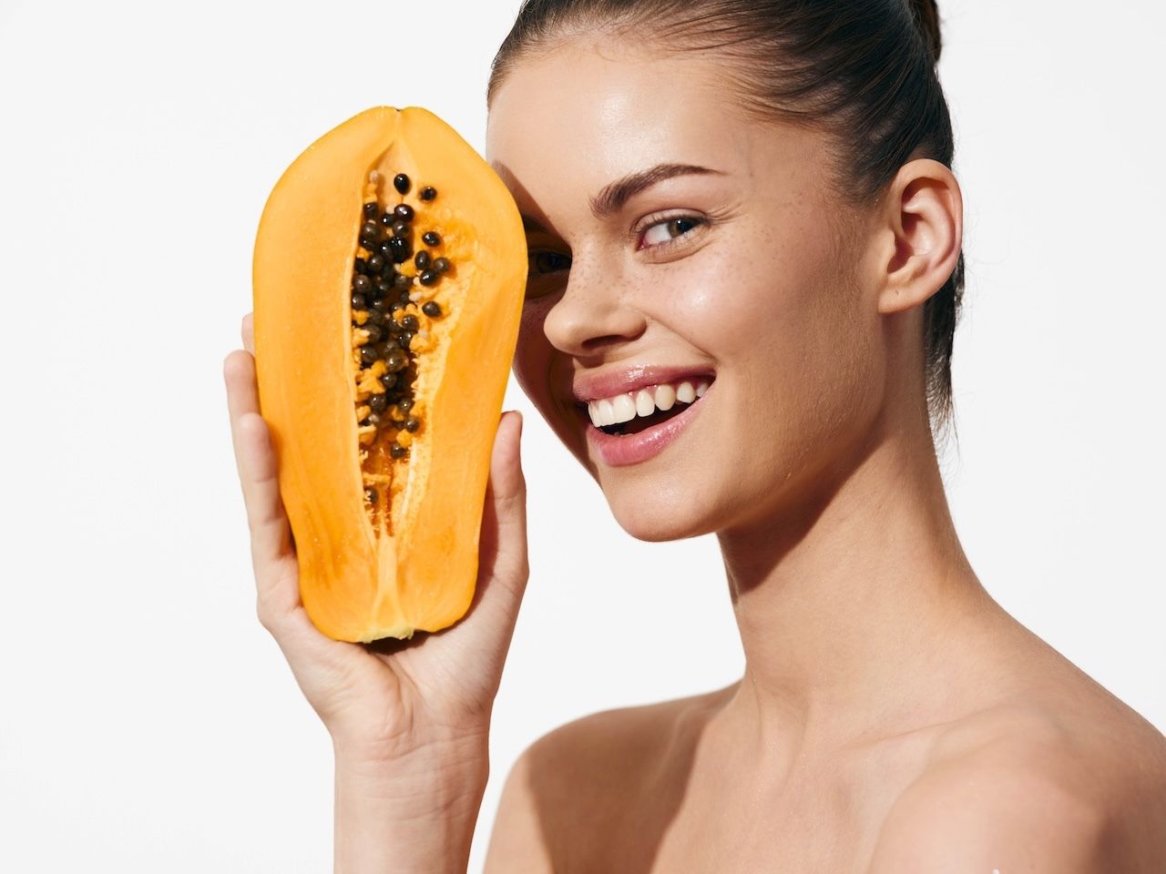 woman holding papaya fruit